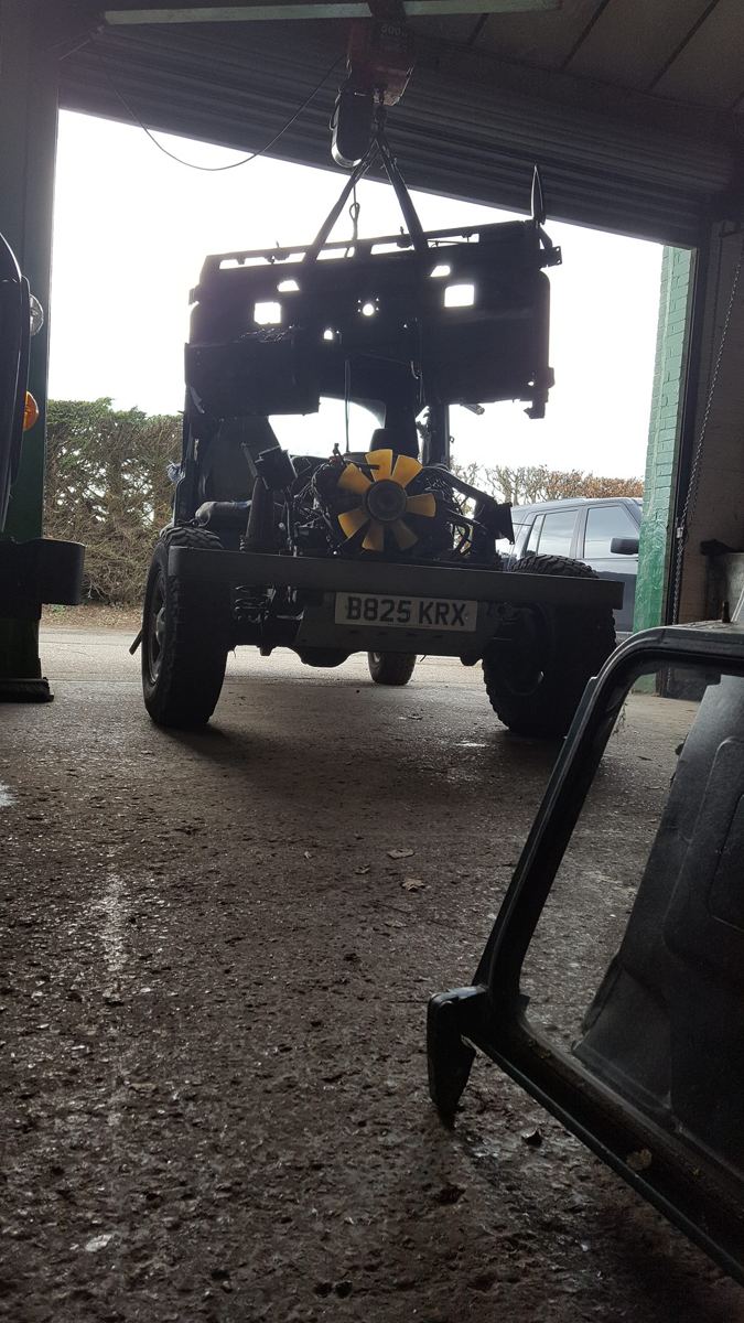 Land Rover chassis with the bulkhead raised at the workshop door
